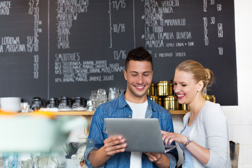 Quick Loans Direct shares photo of small business owners receiving small business lending.